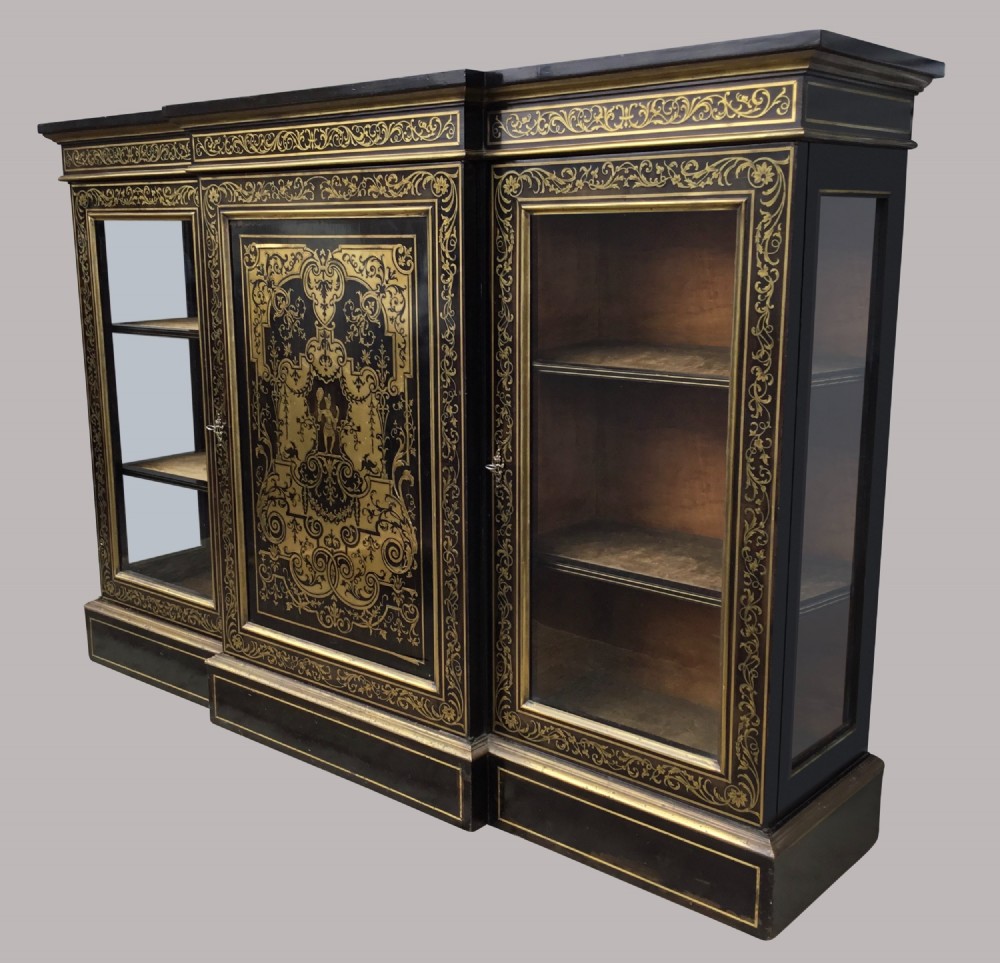 A 19th-century ebony breakfront side cabinet featuring central Boulle brass marquetry door panels flanked by two glazed display cabinet doors. View IV