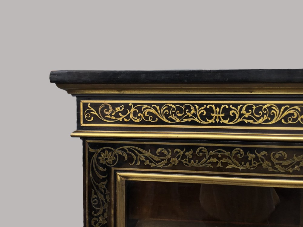 A 19th-century ebony breakfront side cabinet featuring central Boulle brass marquetry door panels flanked by two glazed display cabinet doors. View V
