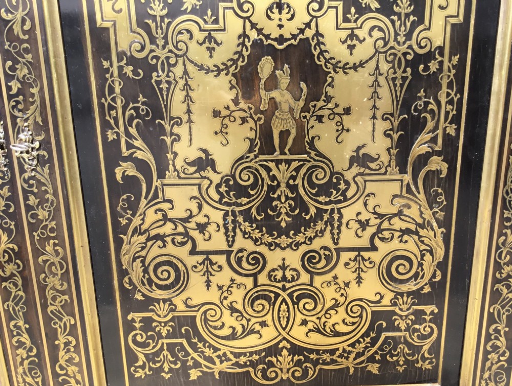A 19th-century ebony breakfront side cabinet featuring central Boulle brass marquetry door panels flanked by two glazed display cabinet doors. View VII