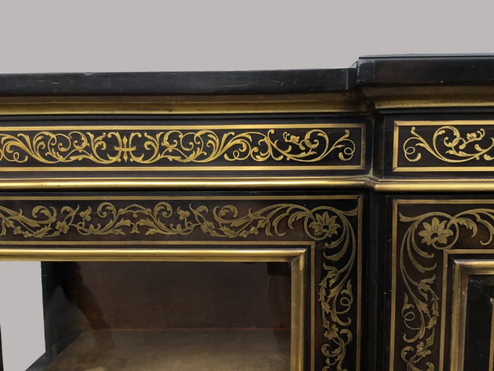 A 19th-century ebony breakfront side cabinet featuring central Boulle brass marquetry door panels flanked by two glazed display cabinet doors. View XI