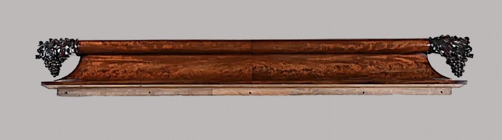 A long George IV figured mahogany pelmet featuring carved acanthus leaves and grape cluster finials at either end. View XIII