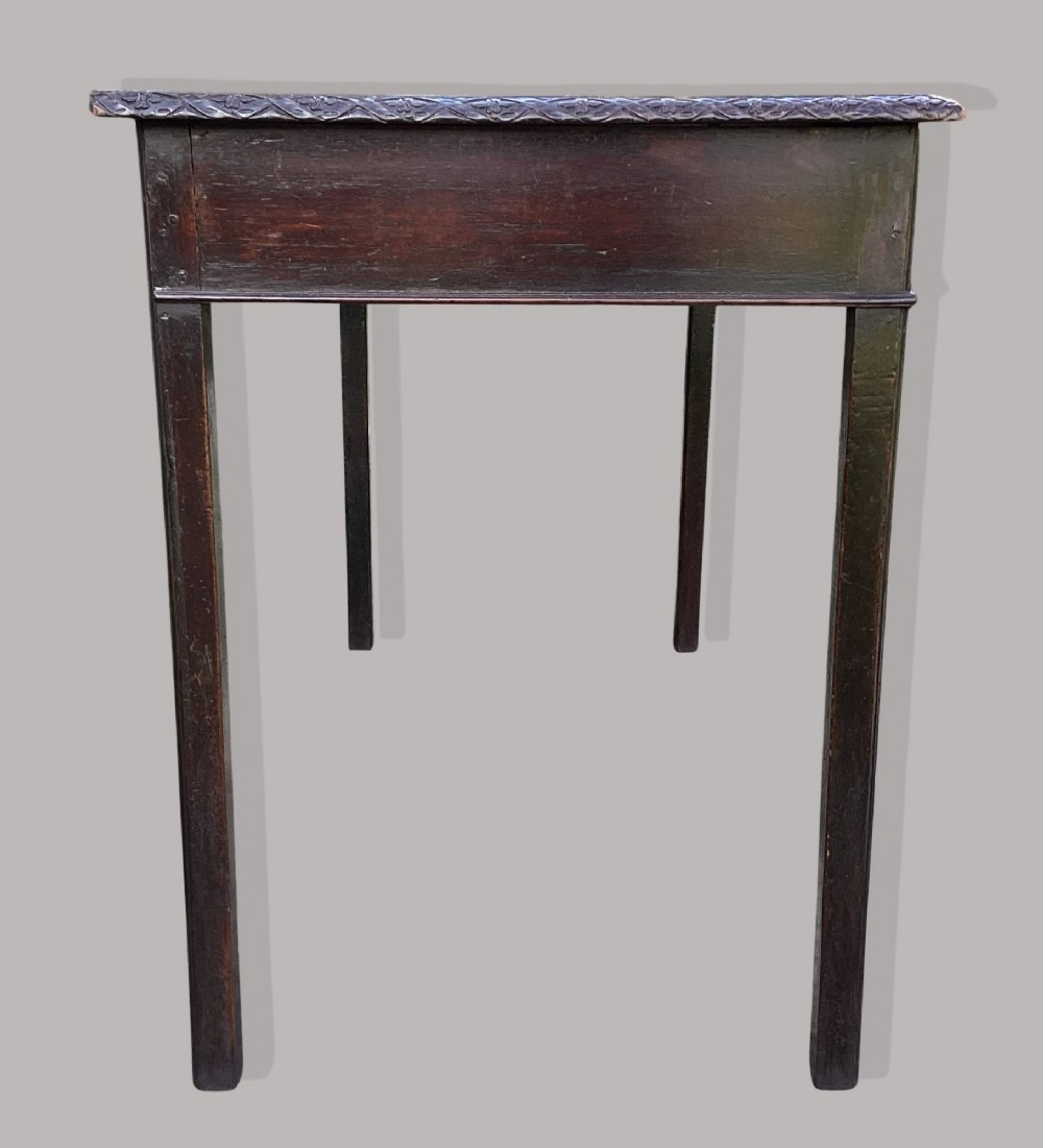 A George III mahogany side table featuring a rectangular carved-edge top, plain frieze, and straight legs. View VI
