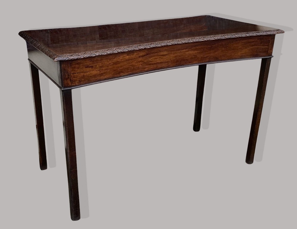 A George III mahogany side table featuring a rectangular carved-edge top, plain frieze, and straight legs. View VIII