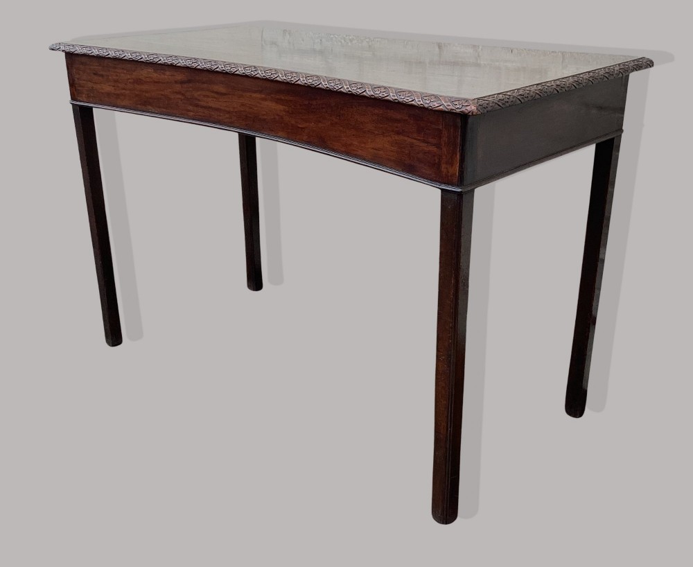 A George III mahogany side table featuring a rectangular carved-edge top, plain frieze, and straight legs. View IX