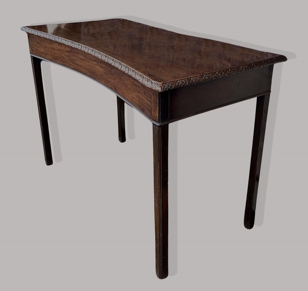 A George III mahogany side table featuring a rectangular carved-edge top, plain frieze, and straight legs. View X