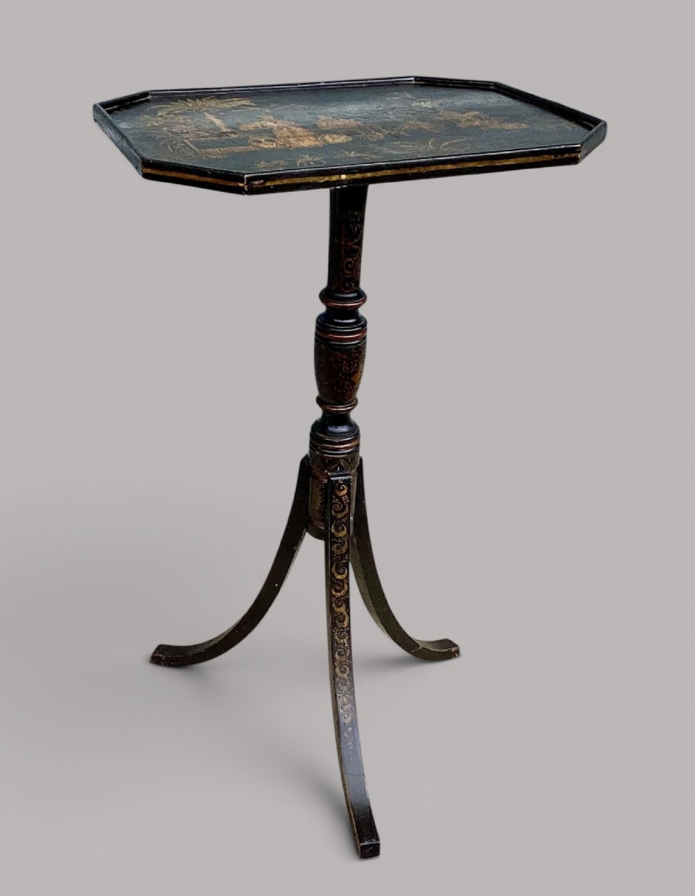 A Regency black lacquered octagonal top wine table with gilded Chinoiserie figure decoration on a turned tripod base. View V