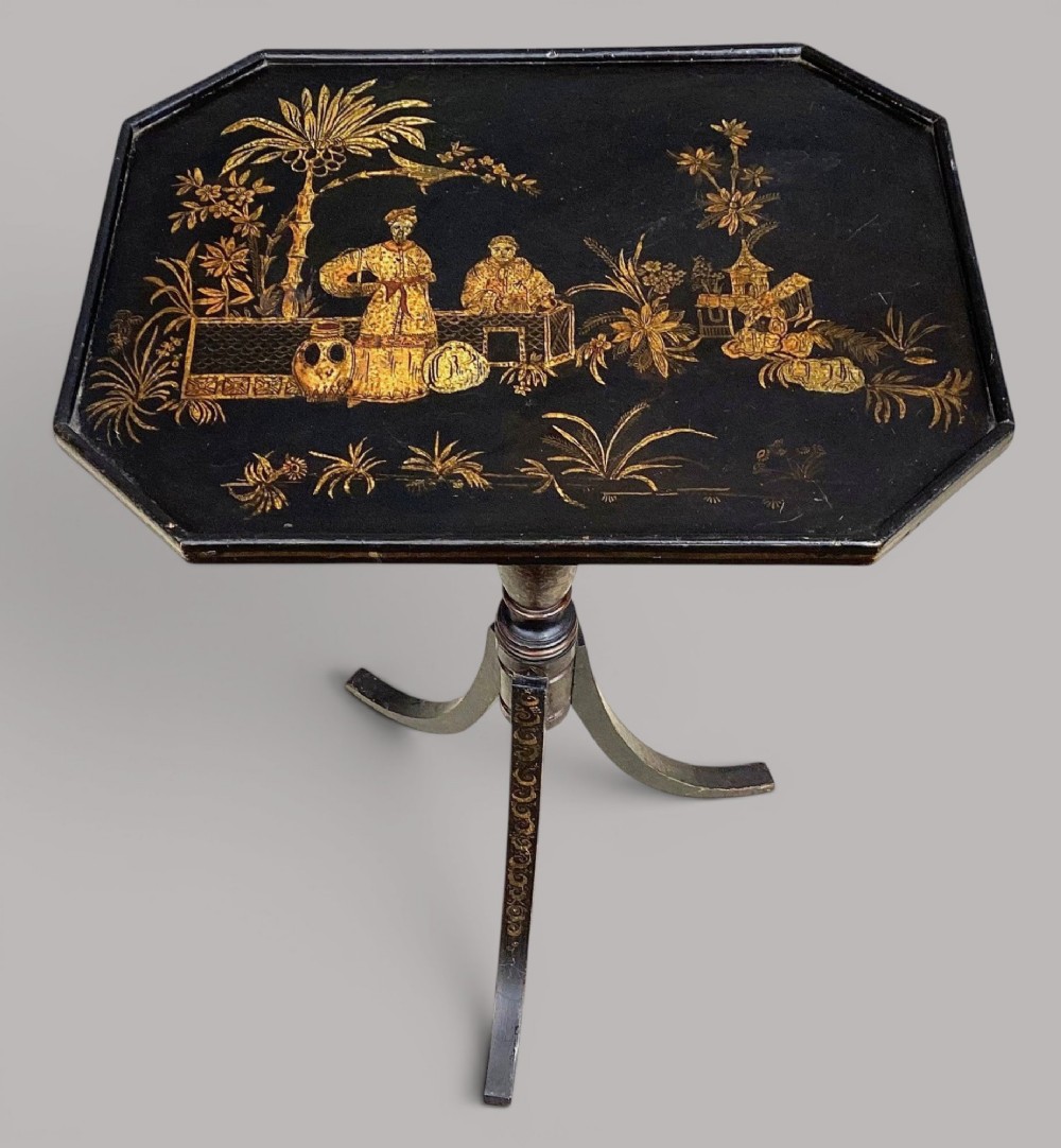A Regency black lacquered octagonal top wine table with gilded Chinoiserie figure decoration on a turned tripod base. View VII