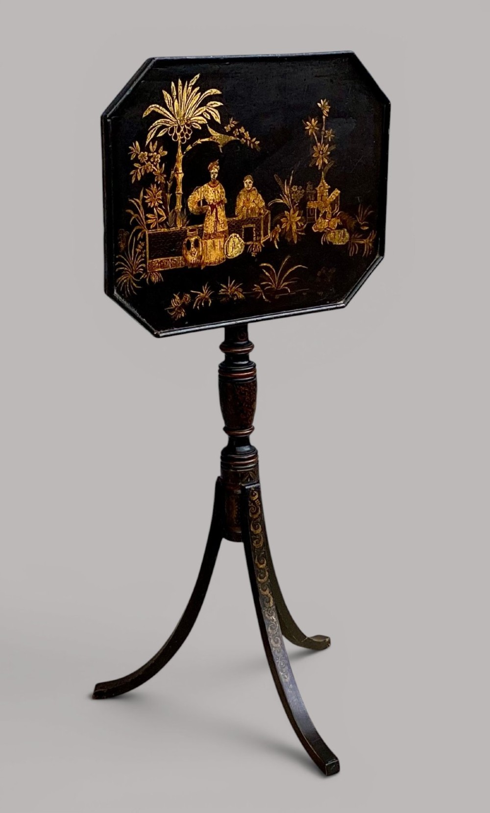 A Regency black lacquered octagonal top wine table with gilded Chinoiserie figure decoration on a turned tripod base. View VIII