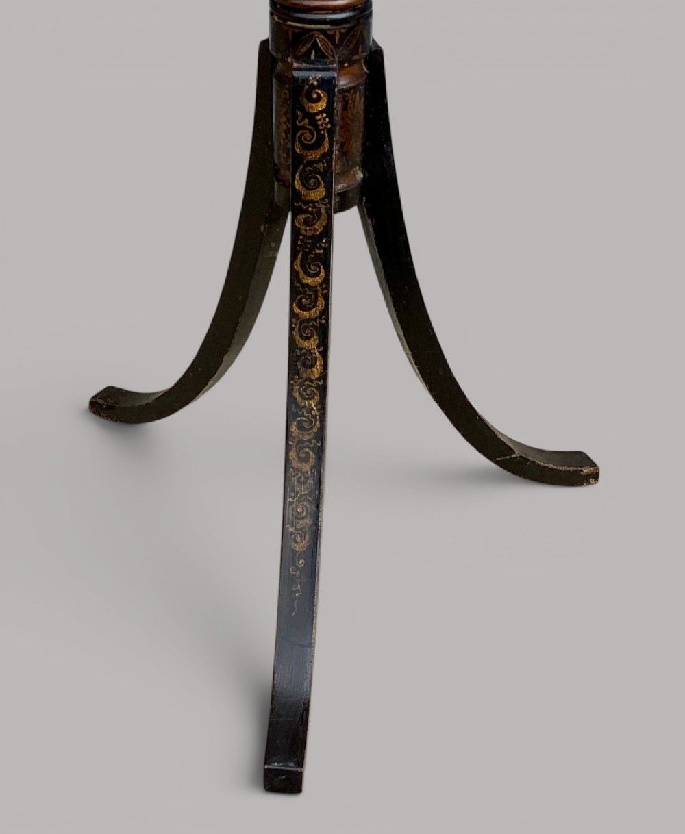 A Regency black lacquered octagonal top wine table with gilded Chinoiserie figure decoration on a turned tripod base. View IX
