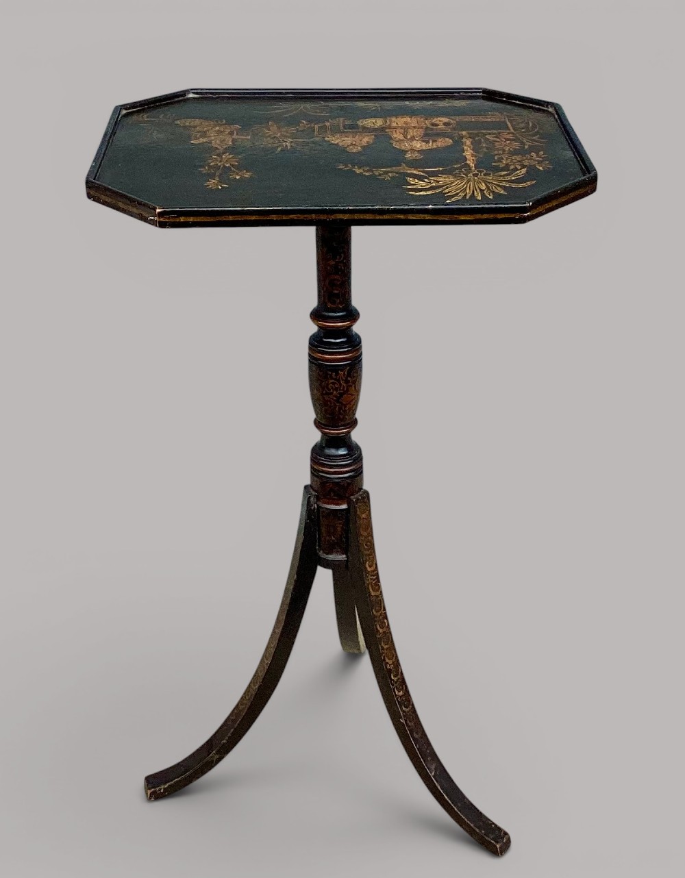 A Regency black lacquered octagonal top wine table with gilded Chinoiserie figure decoration on a turned tripod base. View X