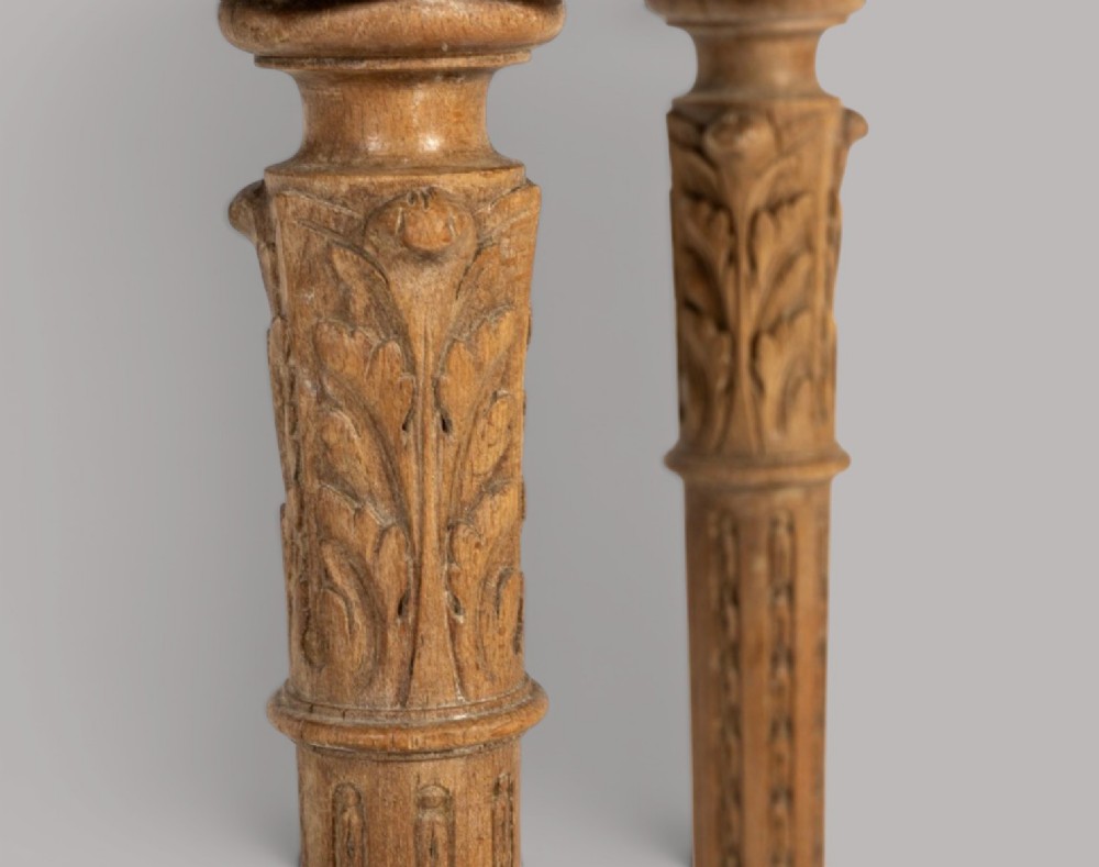 An 18th-century Louis XVI demilune console table featuring a variegated marble top, pierced carved floral frieze, fluted tapered legs, and a decorative central stretcher. View VI