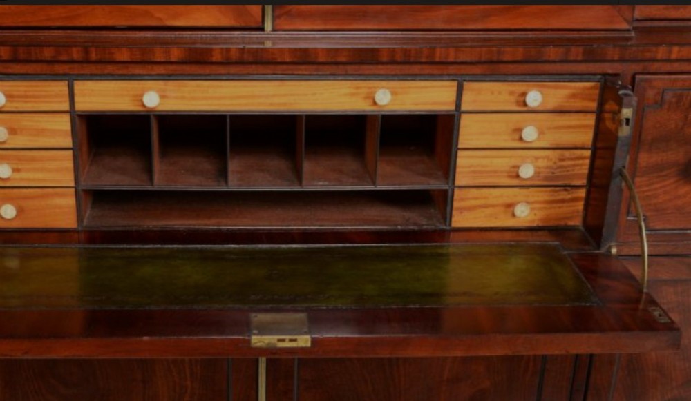 A pair of Regency mahogany library bookcases with diamond astragal glazed upper doors and panelled lower cupboard doors. View VI