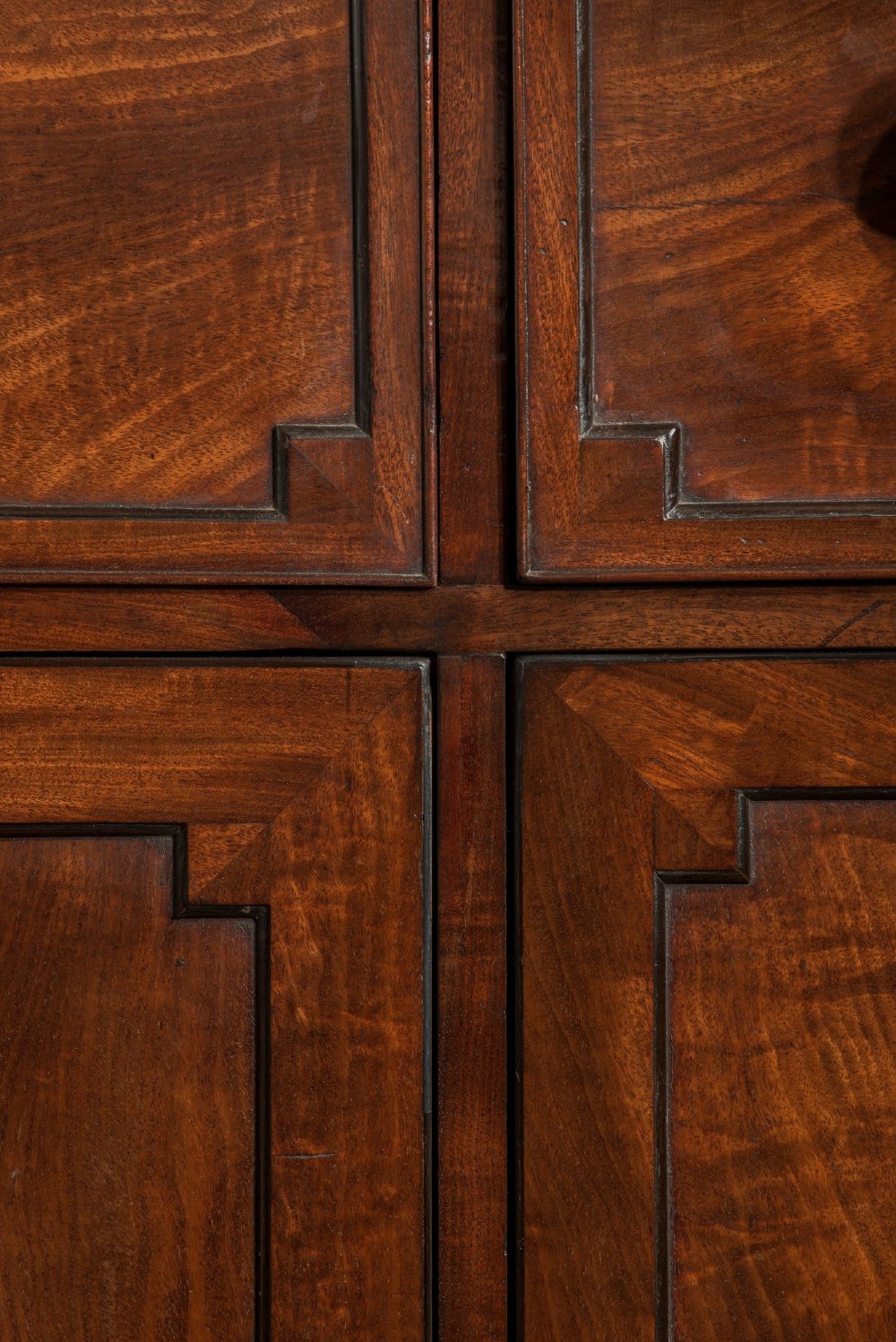 A pair of Regency mahogany library bookcases with diamond astragal glazed upper doors and panelled lower cupboard doors. View VII