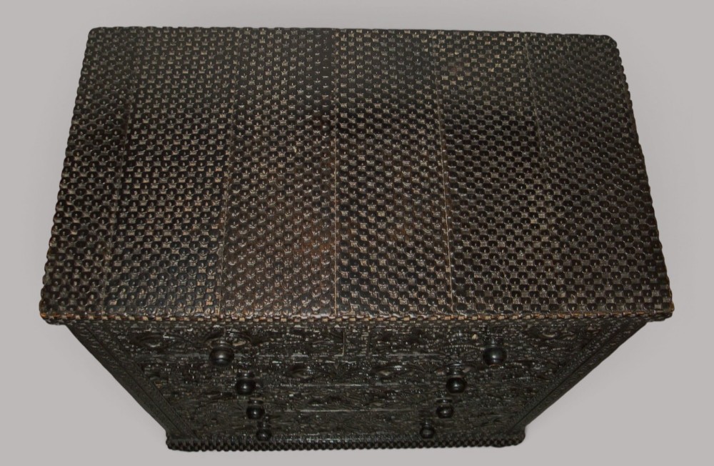 A 19th-century small ebonised chest of drawers featuring relief foliage carving across all surfaces, turned wooden knobs, and short bun feet. View VIII