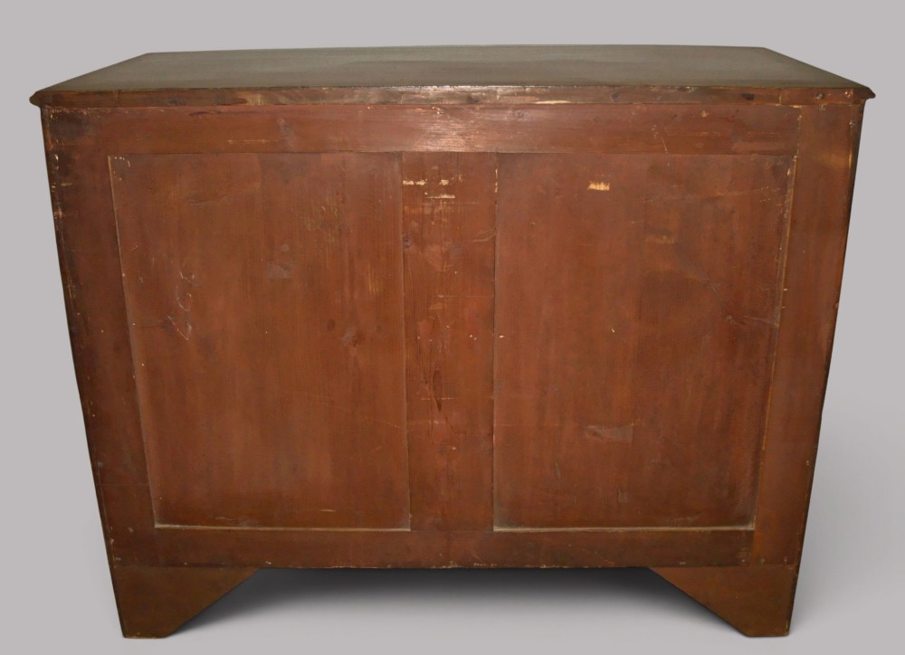 A George III mahogany bowfront chest of drawers featuring four graduated drawers with brass handles and splay feet. View VIII