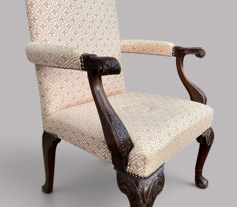 An 18th-century style George II mahogany open armchair upholstered in a cream and red geometric patterned fabric with carved cabriole legs. View III