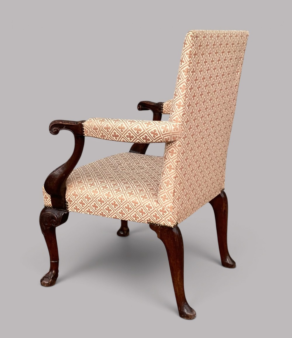 An 18th-century style George II mahogany open armchair upholstered in a cream and red geometric patterned fabric with carved cabriole legs. View XI