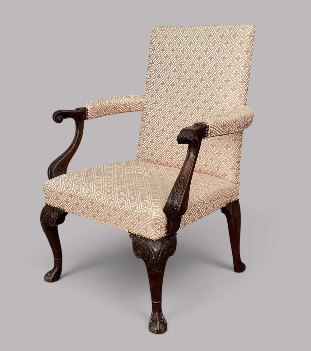 An 18th-century style George II mahogany open armchair upholstered in a cream and red geometric patterned fabric with carved cabriole legs. View XII