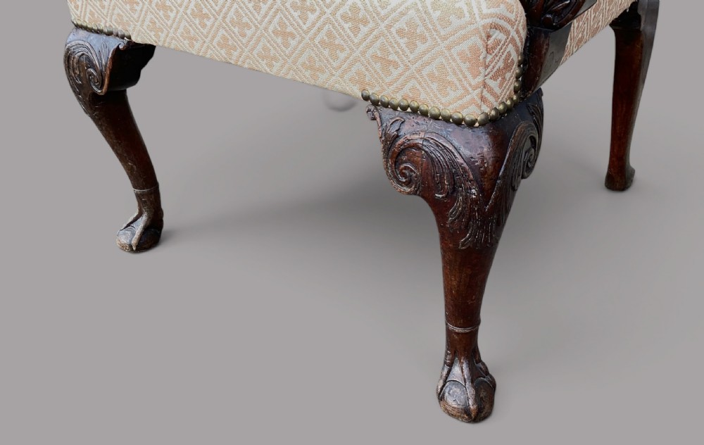 An 18th-century style George II mahogany open armchair upholstered in a cream and red geometric patterned fabric with carved cabriole legs. View XIII