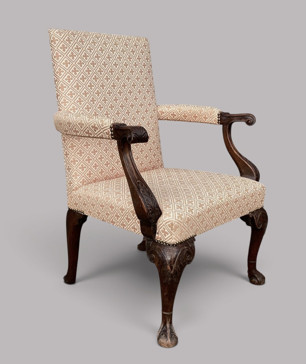 An 18th-century style George II mahogany open armchair upholstered in a cream and red geometric patterned fabric with carved cabriole legs. View XV