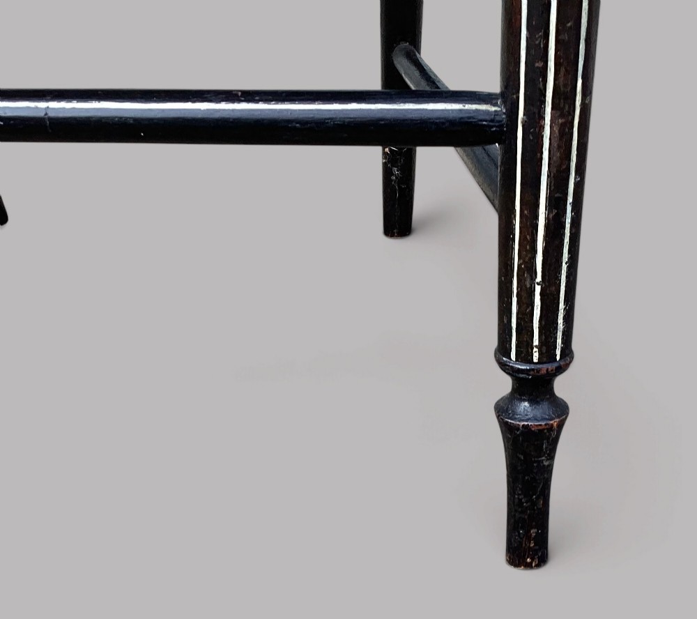 A Regency dark-painted wooden elbow chair featuring hand-painted white line decoration, an X-back splat, and a woven rush seat. View XIII