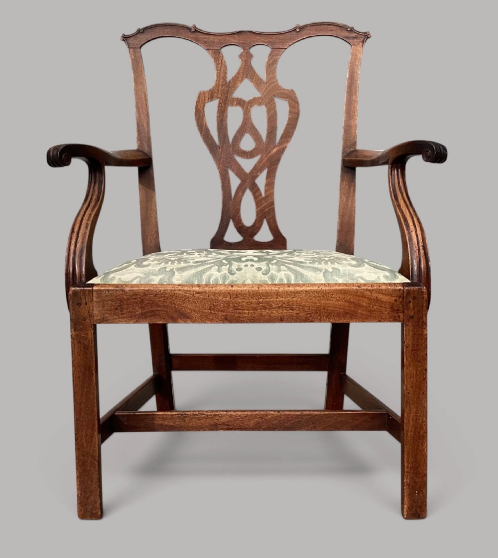 A George III mahogany open armchair featuring a carved pierced back splat, curved armrests, and a patterned fabric seat. View V