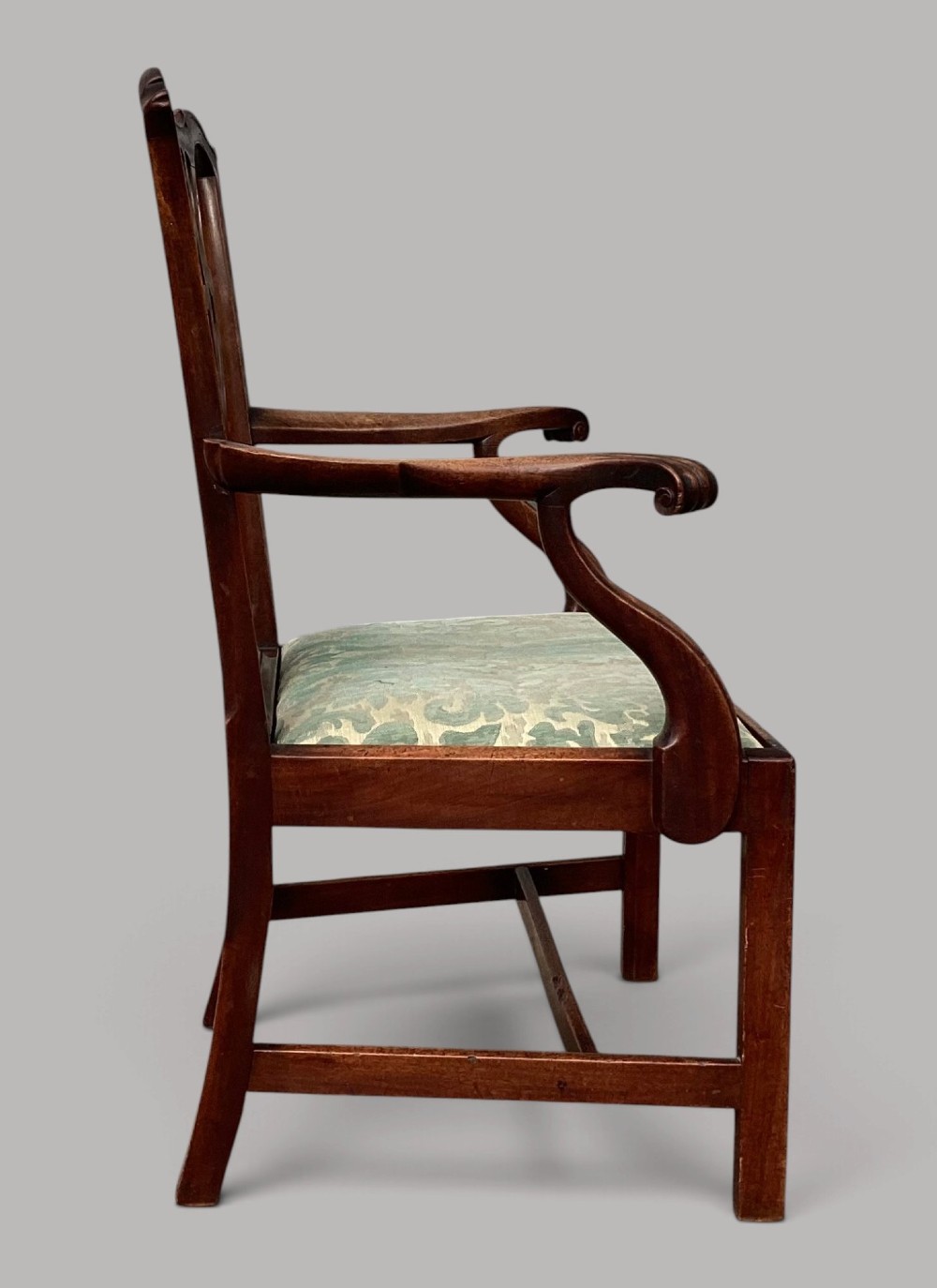 A George III mahogany open armchair featuring a carved pierced back splat, curved armrests, and a patterned fabric seat. View VIII