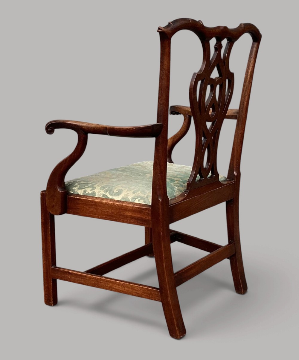A George III mahogany open armchair featuring a carved pierced back splat, curved armrests, and a patterned fabric seat. View IX