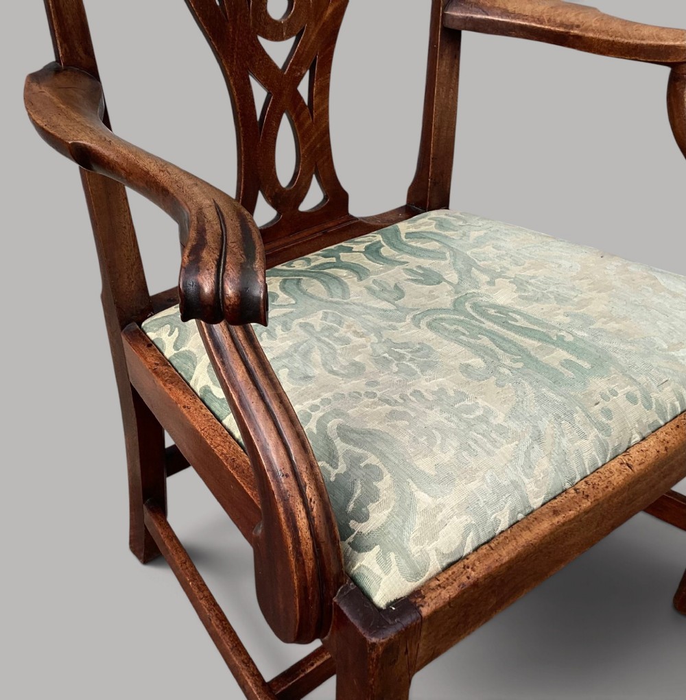 A George III mahogany open armchair featuring a carved pierced back splat, curved armrests, and a patterned fabric seat. View XI