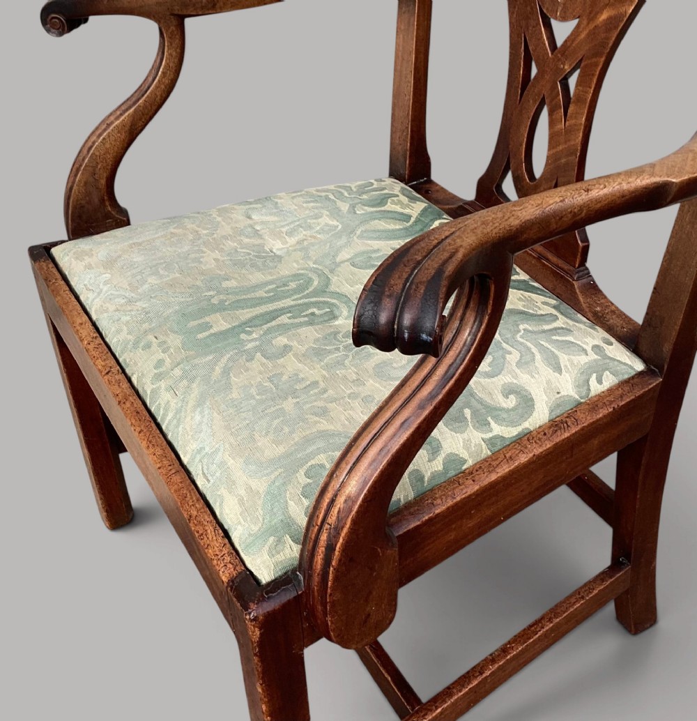 A George III mahogany open armchair featuring a carved pierced back splat, curved armrests, and a patterned fabric seat. View XIII