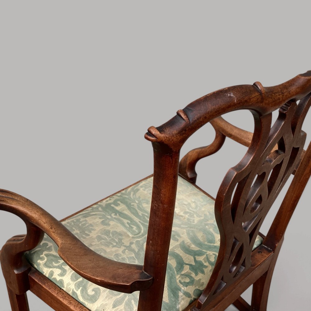 A George III mahogany open armchair featuring a carved pierced back splat, curved armrests, and a patterned fabric seat. View XIV