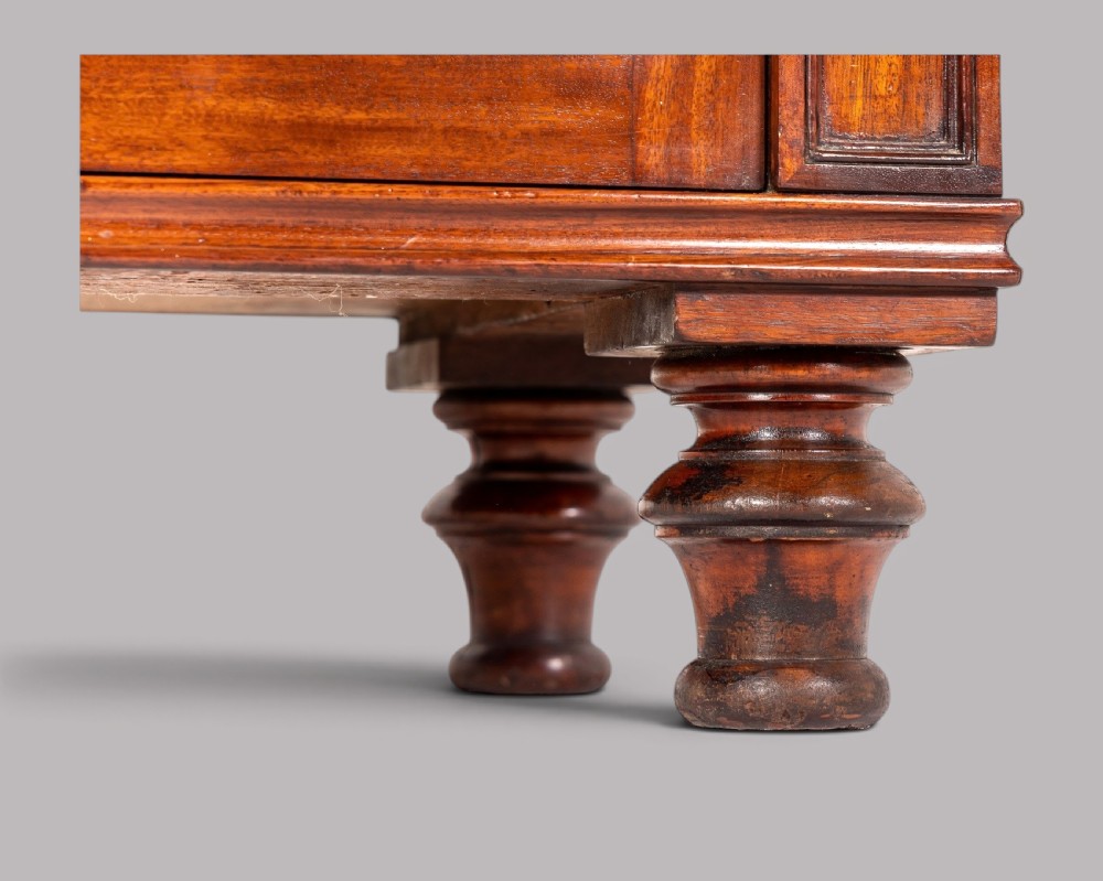 A matching pair of Regency mahogany side cabinets featuring panelled cupboard doors and tiered upper shelves supported by carved scroll uprights. View IV
