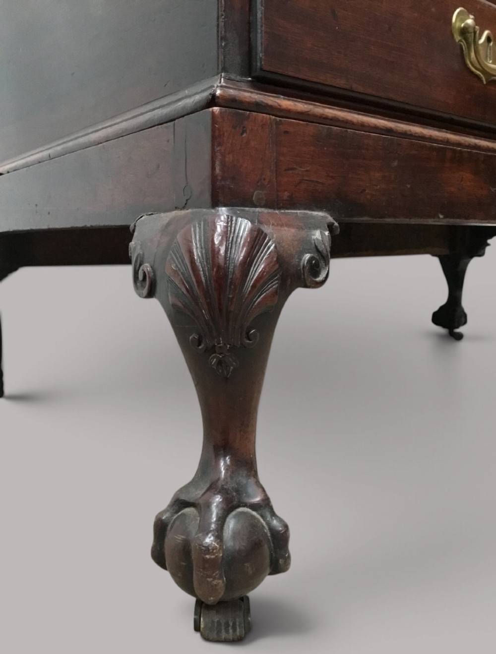 A dark mahogany George II silver chest on stand featuring two lower drawers, brass handles, a central keyhole escutcheon, and carved cabriole legs. View II