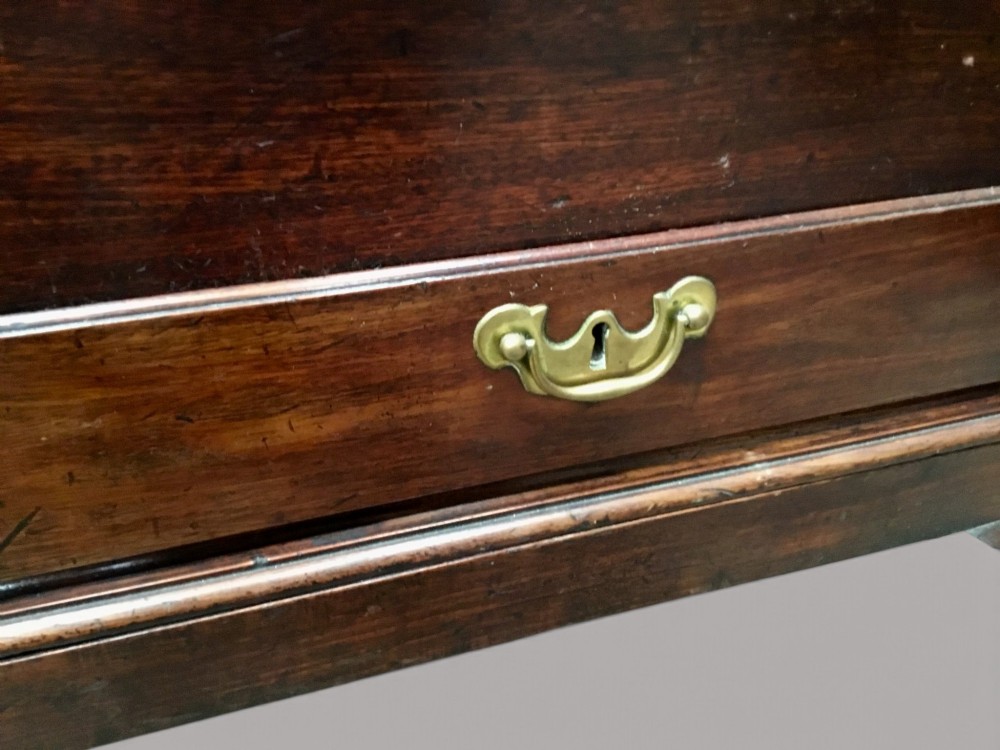 A dark mahogany George II silver chest on stand featuring two lower drawers, brass handles, a central keyhole escutcheon, and carved cabriole legs. View V