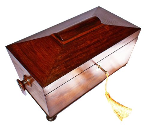 fig 1. An open William IV sarcophagus-shaped dark wood tea caddy containing two lidded canisters and a central glass mixing bowl.