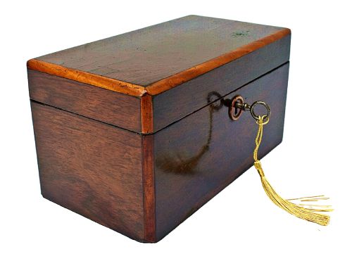 fig 1. An open dark wood William IV tea caddy featuring two internal lidded compartments, a red embossed paper lining inside the lid, and a brass key with a tassel inserted in the lock.