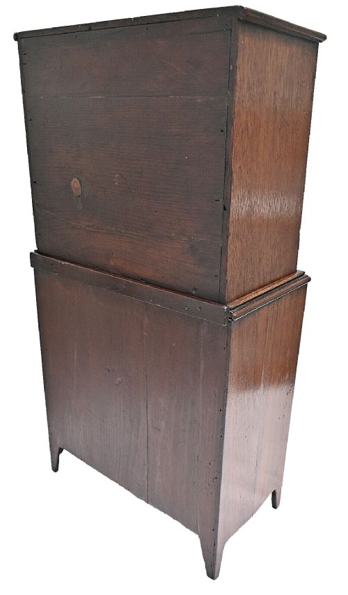 A dark mahogany Georgian apprentice chest of four drawers with a removable two-door glazed cabinet upper section. View V
