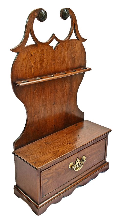 An antique carved oak spoon rack features a shaped scroll crest, a slotted rack, and a lower drawer with a brass drop handle. View VIII