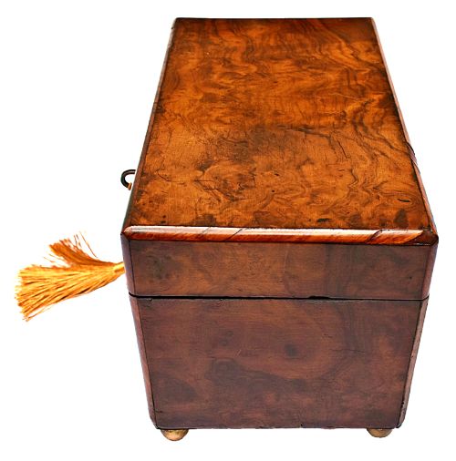 fig 2. A rectangular mid-Victorian tea caddy crafted from figured burr walnut veneer with a central brass keyhole escutcheon and key.