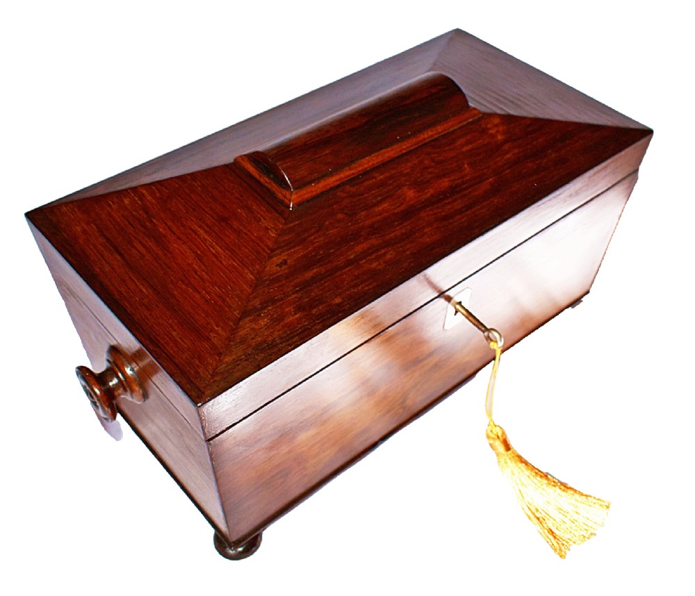 An open William IV sarcophagus-shaped dark wood tea caddy containing two lidded canisters and a central glass mixing bowl. View II