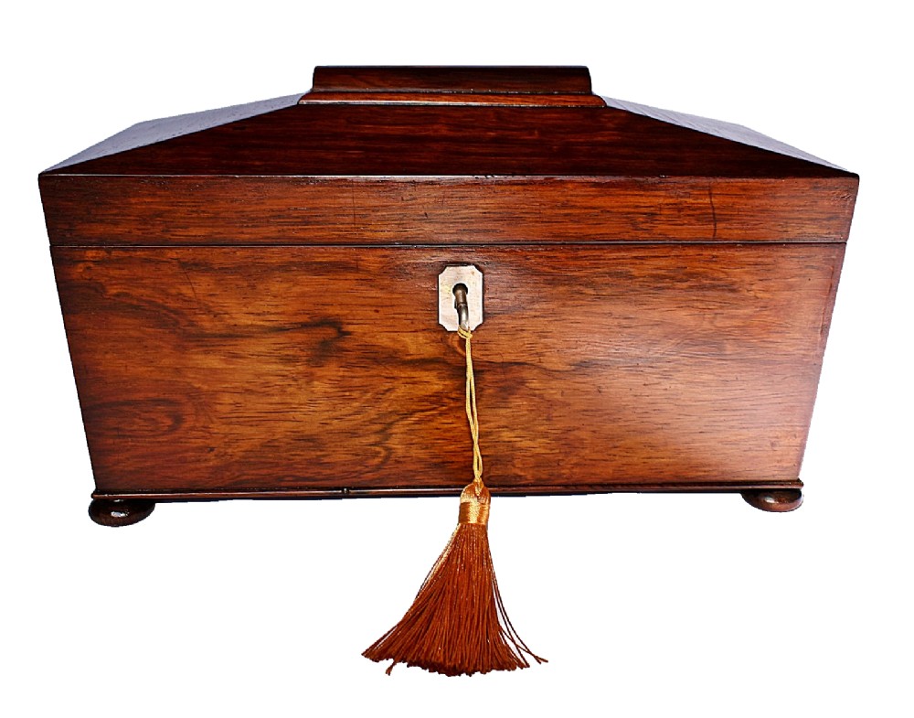 An open William IV sarcophagus-shaped dark wood tea caddy containing two lidded canisters and a central glass mixing bowl. View III