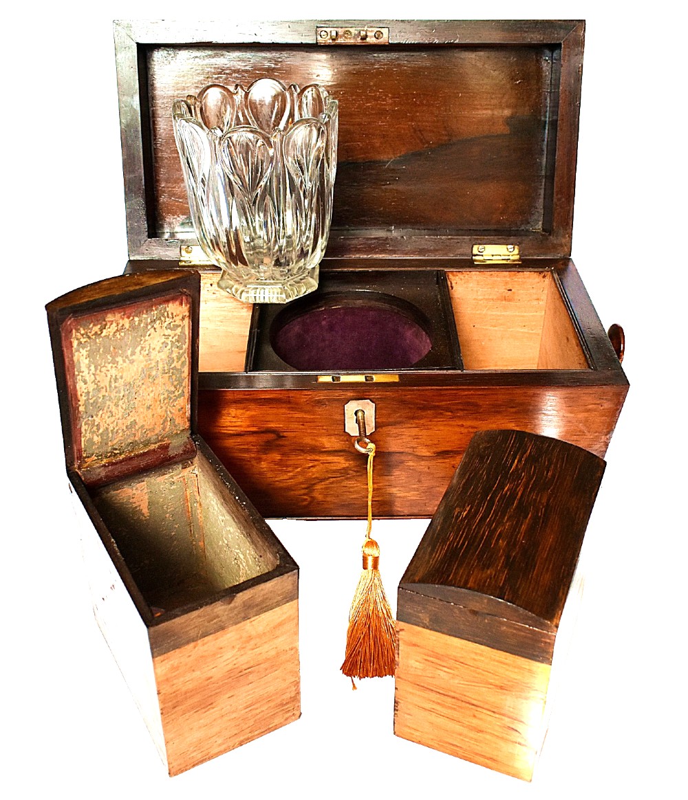 An open William IV sarcophagus-shaped dark wood tea caddy containing two lidded canisters and a central glass mixing bowl. View X