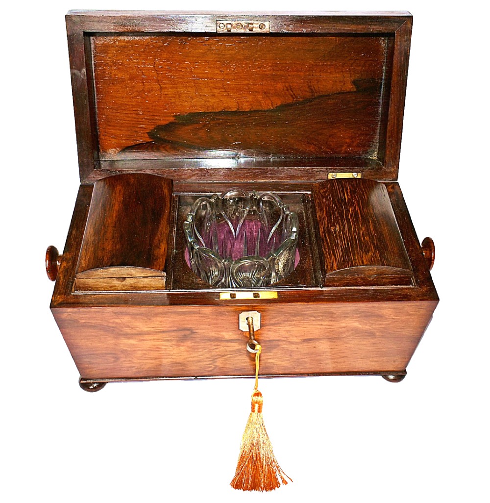 An open William IV sarcophagus-shaped dark wood tea caddy containing two lidded canisters and a central glass mixing bowl. View XII