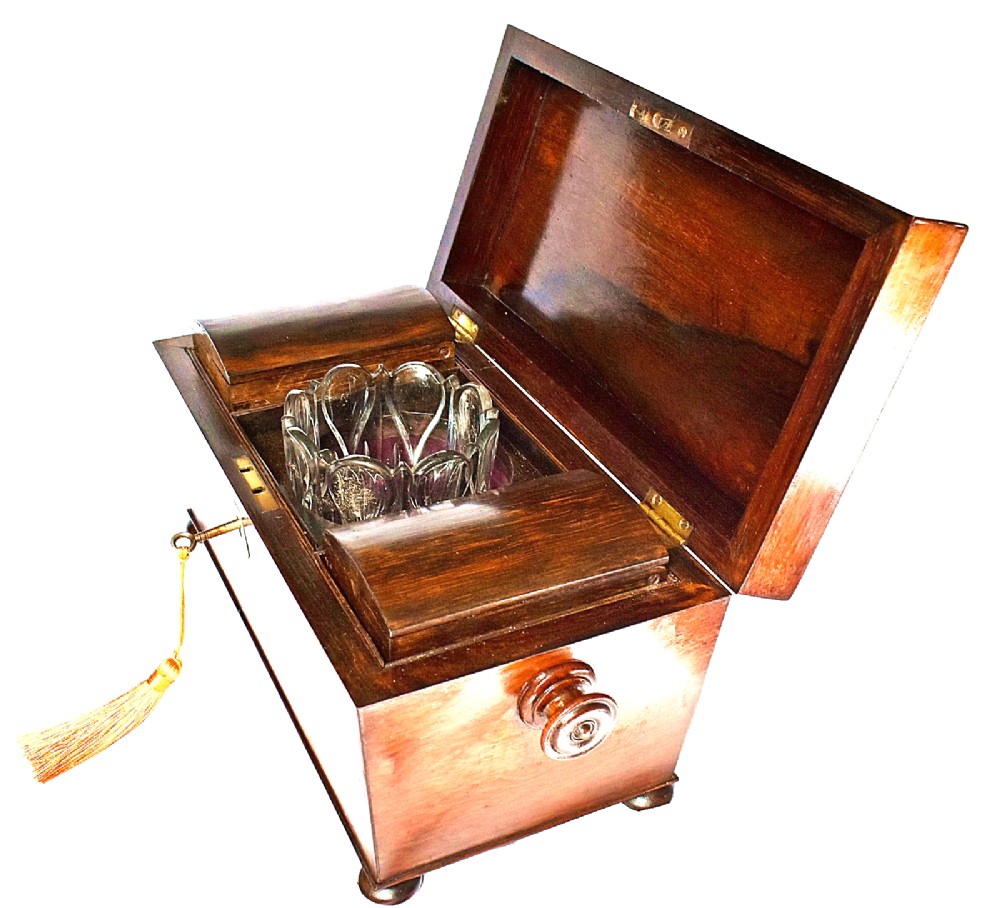 An open William IV sarcophagus-shaped dark wood tea caddy containing two lidded canisters and a central glass mixing bowl. View XIII