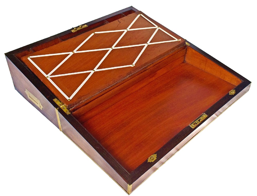An open antique mahogany writing slope featuring a red gold-tooled leather writing surface, brass corner mounts, and dedicated compartments for inkwells. View VIII