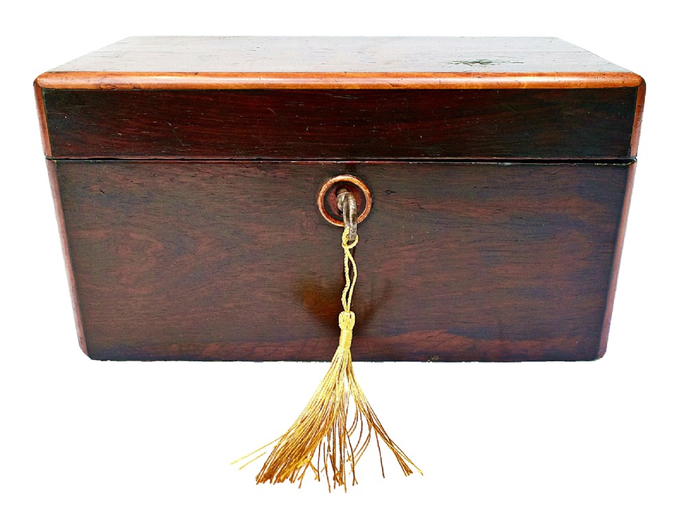 An open dark wood William IV tea caddy featuring two internal lidded compartments, a red embossed paper lining inside the lid, and a brass key with a tassel inserted in the lock. View III
