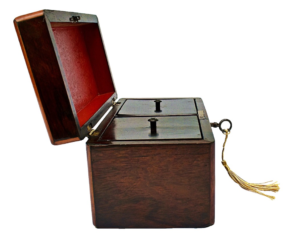 An open dark wood William IV tea caddy featuring two internal lidded compartments, a red embossed paper lining inside the lid, and a brass key with a tassel inserted in the lock. View VII