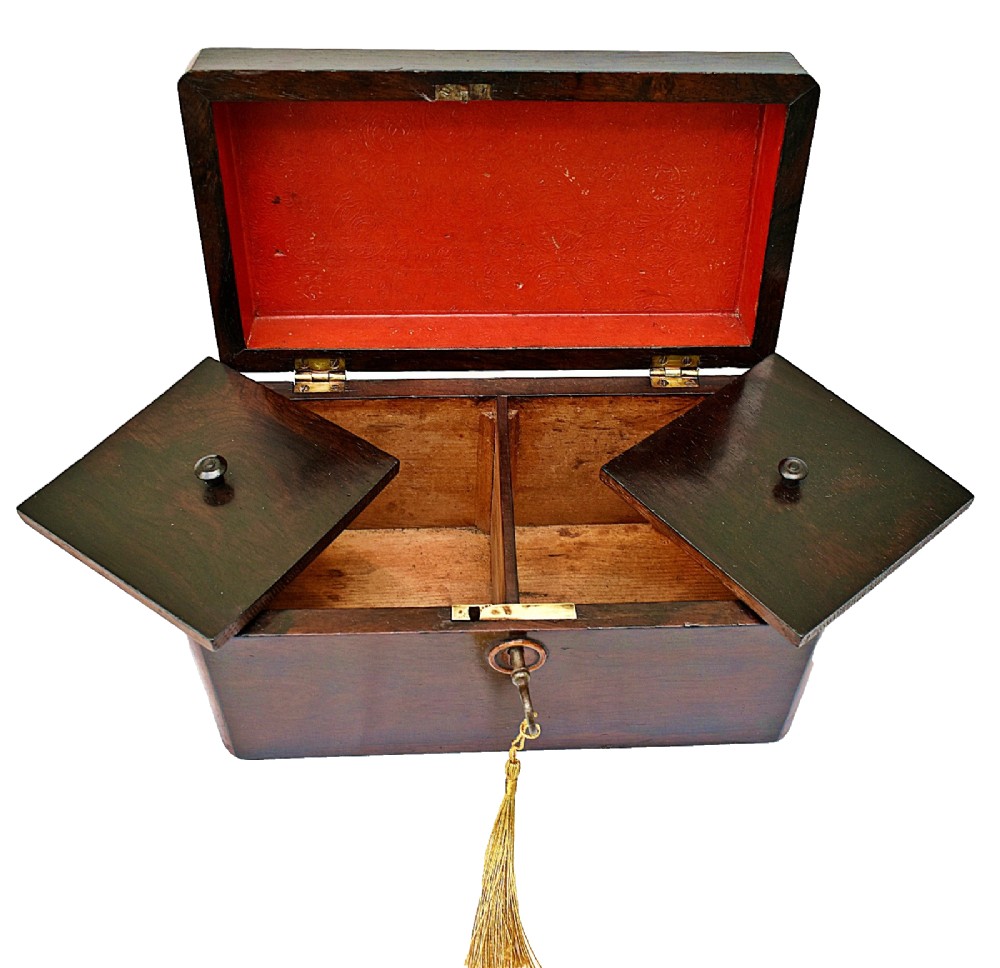 An open dark wood William IV tea caddy featuring two internal lidded compartments, a red embossed paper lining inside the lid, and a brass key with a tassel inserted in the lock. View VIII