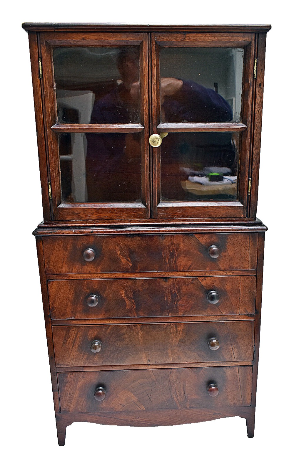 A dark mahogany Georgian apprentice chest of four drawers with a removable two-door glazed cabinet upper section.