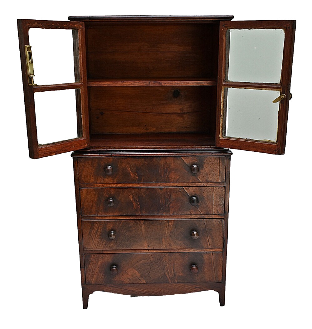 A dark mahogany Georgian apprentice chest of four drawers with a removable two-door glazed cabinet upper section. View VI